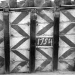 Painted tile, dated to 1754, in the attic of a palazzo in Via della Madonnella 10, photograph by the Soprintendenza ai Monumenti del Lazio, for the cataloguing campaign in 1977. Photo: Archivio della Soprintendenza ai Monumenti del Lazio, SBAS RM 87126